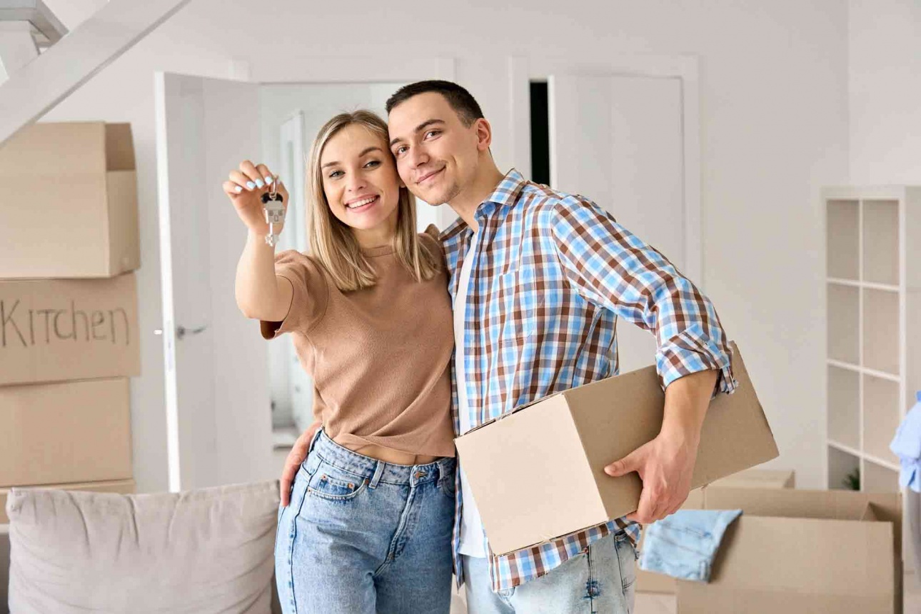 happy_young_couple_first_time_home_owners_holding_keys_new_home.jpg